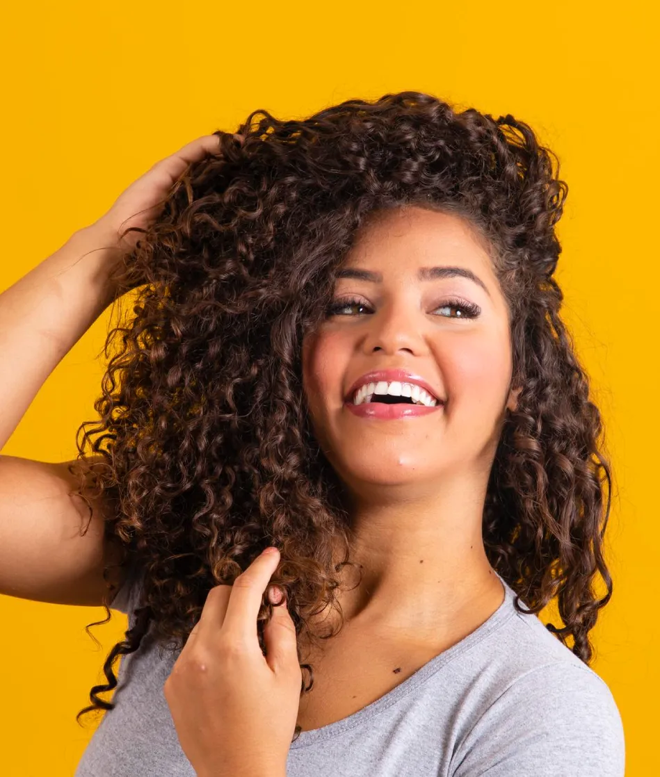 Laughing woman with voluminous curly hair