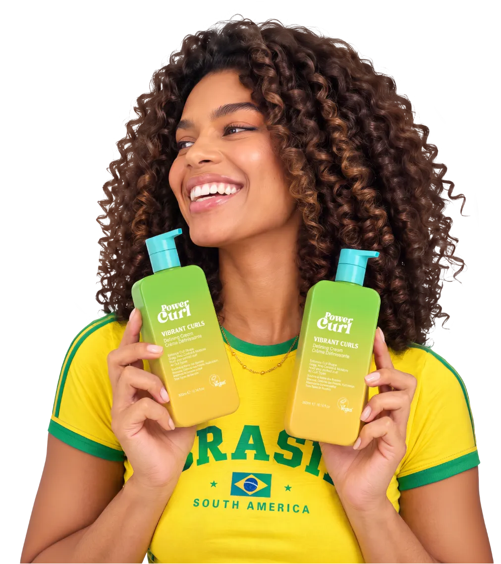 Woman with curly hair holding two bottles of Power Curl Vibrant Curls